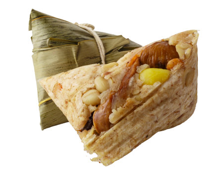 Zongzi or Bacang is a sticky rice dumpling wrapped in bamboo leaves, filled with savory or sweet ingredients, enjoyed during the Dragon Boat Festival. isolated on a white backgroundの写真素材