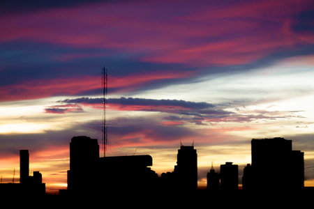 Beautiful sunset sky in Twilight time and silhouette of the city