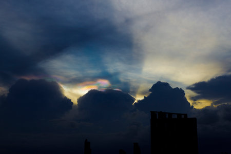 Cloud iridescence or irisation over the dark sky. occurs when sunlight reflects off water droplets...