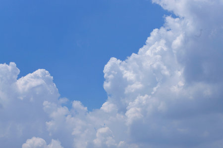 White clouds floating across a clear blue sky