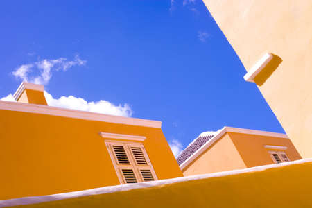 An upwoard and diagonal shot of traditional colonial brightly painted buildings in Curacao´s capital: Willemstadの写真素材