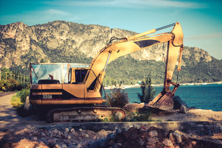 Excavator machine on site in vintage styleの写真素材