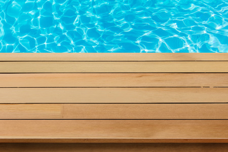 wood table top with blue sea background