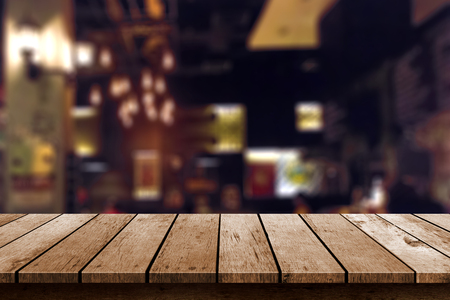 wooden table in blur resturant lights backgroundの写真素材