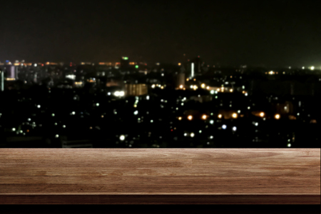 wood table top on night city backgroundの写真素材