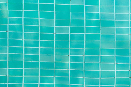 Turquoise swimming pool water surface and ripple wave background. Summer abstract reflection caustics in swimming pool.の写真素材