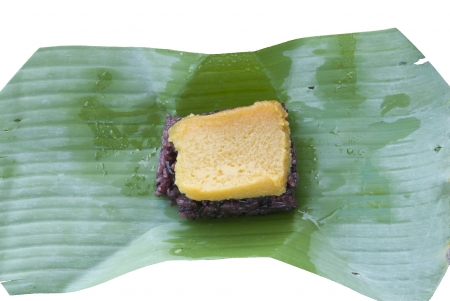 Thai dessert, Steamed sticky rice with egg custard, wrapped in banana leaves の写真素材