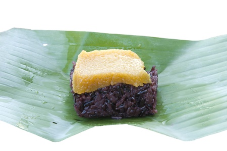 Thai dessert, Steamed sticky rice with egg custard, wrapped in banana leaves の写真素材