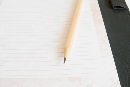 Notebook and pencil on white background.の写真素材