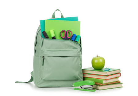 School backpack with stationery and apple on white background. Back to school conceptの素材