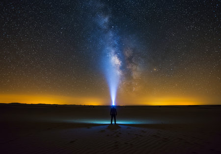 Man watching the milky way over the dunes in the Sahara desert