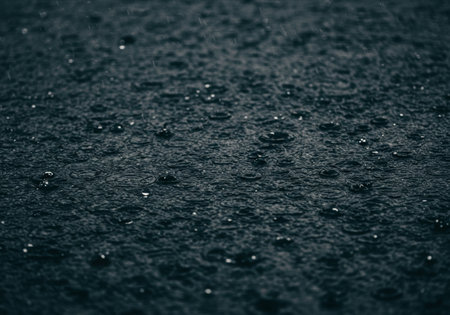 Raindrops on the surface of the water. Dark blue background.の写真素材