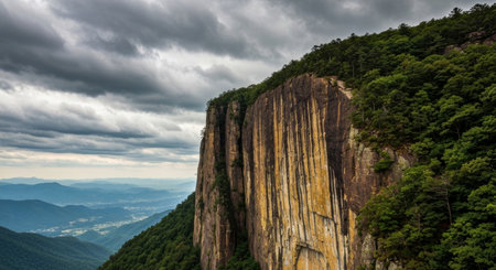 Mountain landscape with rocks in the foreground and cloudy sky in the backgroundの写真素材
