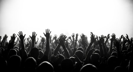 Crowd cheering at a music festival - black and white image.の素材