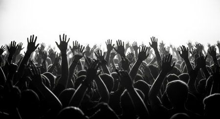 Crowd with hands raised at a music festival - black and whiteの素材