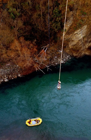A bungee jumper is waiting to be picked up by the rescue boat. New Zealand.