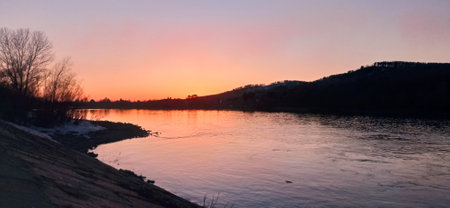 Sunset on the river. The sun is reflected in the water.の写真素材