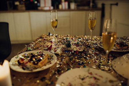 Scattered confetti over dining table after Christmas party.