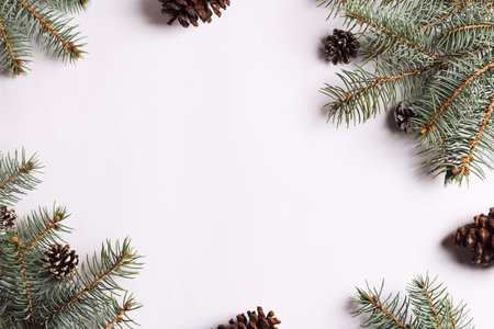 Christmas decoration composition pine cones spruce branches on white festive table isolated. New...