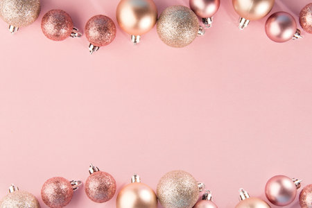 From above shot of bright glittering baubles composed in row on pink background. christmas concept. Horizontal with place for textの写真素材