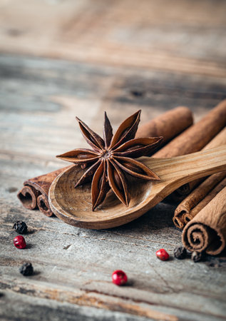 Composition with star anise and cinnamon sticks on a wooden background close up.の写真素材