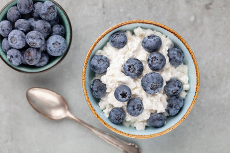 Cottage cheese with blueberry, fresh berries, keto healthy breakfast concept, top view.の写真素材