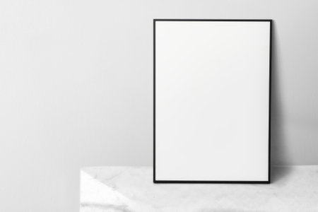 Picture frame leaning against the wall with house plantの写真素材