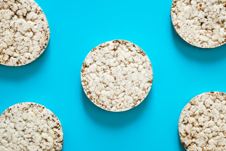 Creative layout made of rice cakes on a blue background, Flat lay, Food concept.の写真素材