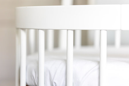 Wooden baby room furniture, white bed crib, baby bedroom modern interior.の写真素材