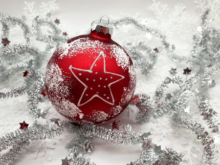 Red Christmas ball with silver tinsel and snowflake on white backgroundの写真素材