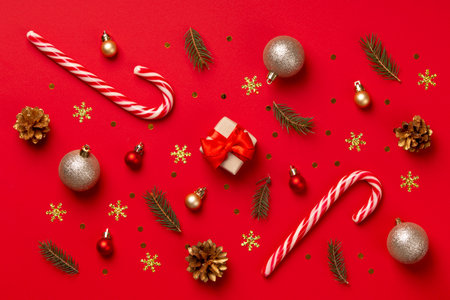 Christmas composition. Gifts, Christmas decorations on red background. Flat lay, top view, copy spaceの写真素材