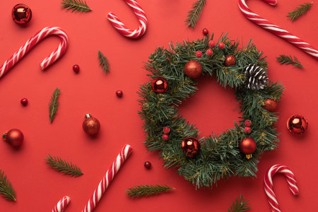 Christmas wreath on red background. Top view with copy space.の写真素材