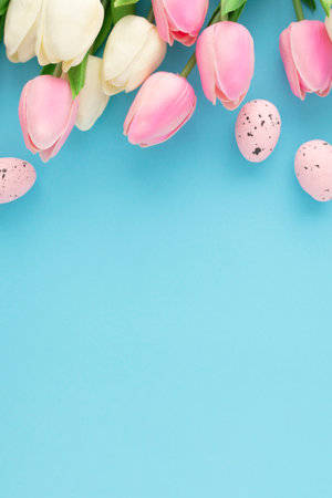 Easter background with tulips and easter eggs on blue background
