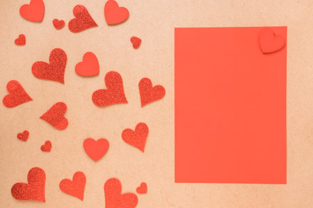 Red paper hearts on a brown background with copy space. Valentine's day concept.の写真素材