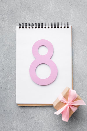 8 March eight with gift box and notebook for your text on grey background