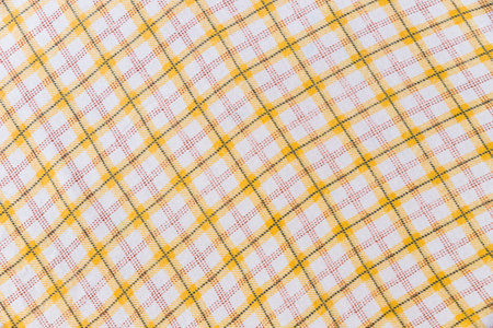 Texture of plaid fabric. Scottish pattern in yellow and white cage.の写真素材