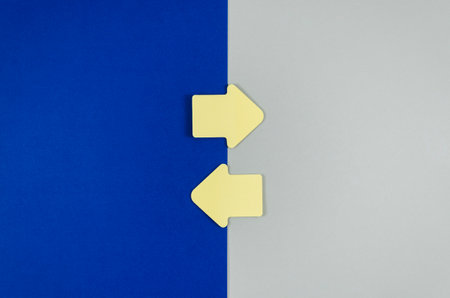Two yellow arrows on a blue and white background. Business concept.