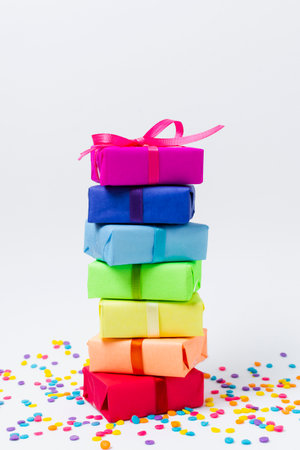 colorful gift boxes with colorful ribbons and confetti on white background