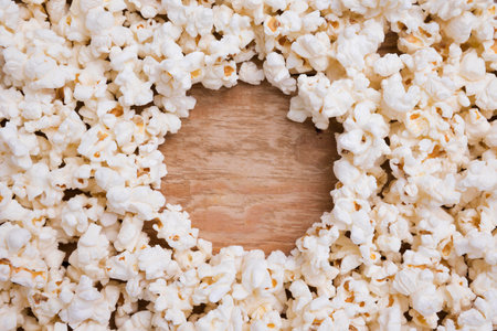 Popcorn frame on wooden background. Top view. Copy space.の写真素材