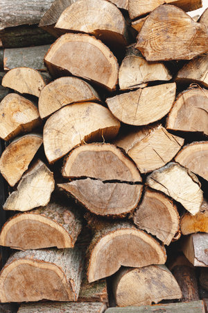 Pile of chopped firewood ready for winter. Natural background.