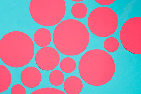 Pink and blue circles on a blue background. Flat lay, top view.の写真素材
