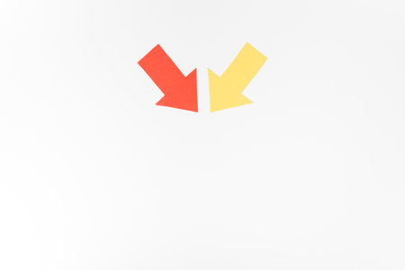 Letter V from red and yellow paper on white background. Isolatedの写真素材