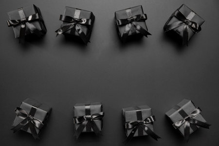 Black gift boxes on a black background. Flat lay, top view.の写真素材