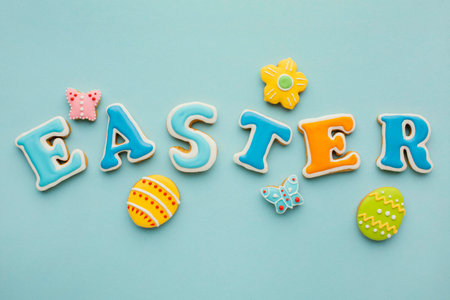 Easter message on blue background with easter eggs and gingerbread cookies