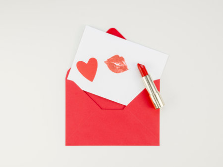 Envelope with a red card and a heart on a white backgroundの写真素材