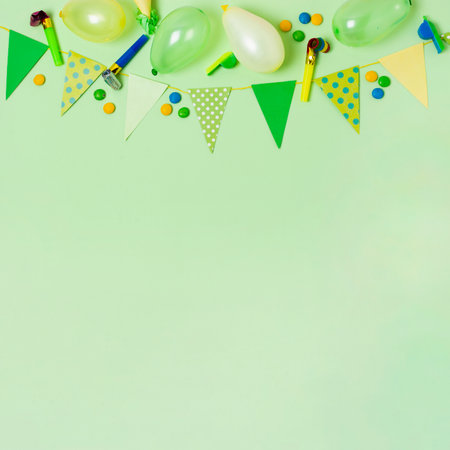 Birthday party background with balloons and confetti on green background. Flat lay, top viewの写真素材