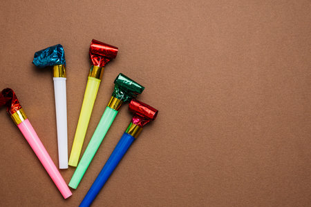 Birthday party items on a brown background with space for text.の写真素材