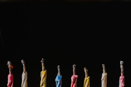 Colorful candies in a row on black background with copy spaceの写真素材