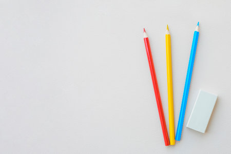 Pencils and eraser on a white background with copy space