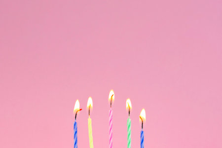 Birthday candles on a pink background. Copyspace for text.の写真素材